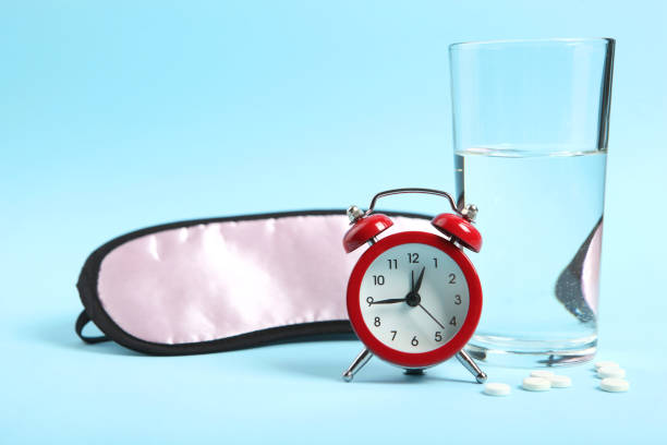 istock Composition on the theme of insomnia on a colored background 1291410863