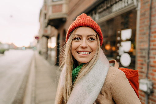 Portrait of a young woman walking on the street, on a cold winter day.