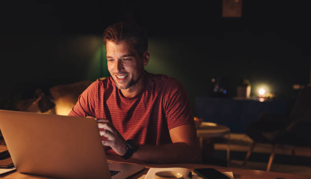 istock Handsome Young Businessman Working on a Laptop at Home 1291413586