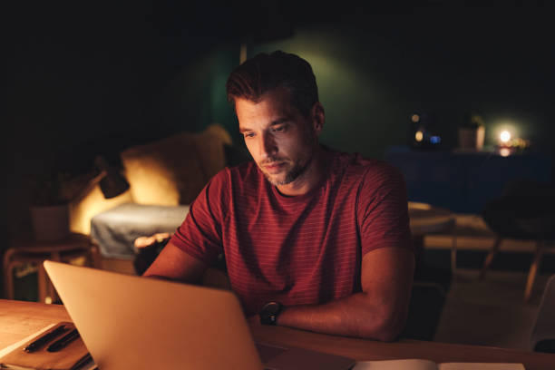 Handsome Young Businessman Working on a Laptop at Home