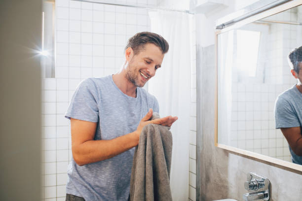 istock Handsome Young Man Drying off with a Towel in the Bathroom 1291413616