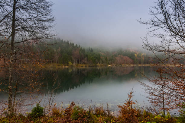 istock beautiful mountain lake with reflection from the autumn forest while hiking 1291413658