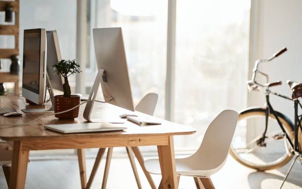 Digital tablet and a laptop on a wooden table in a meeting room
