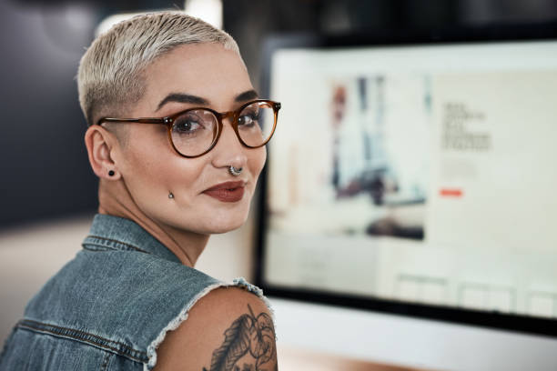 I'm always ready to create and think outside the box Portrait of an attractive young creative businesswoman feeling cheerful while working on a computer inside her office Pierced stock pictures, royalty-free photos & images