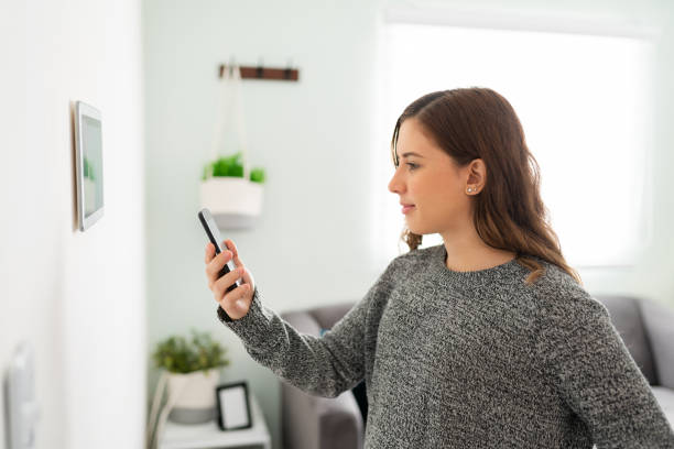 istock Young woman setting up her cellphone to her touch screen 1291415083