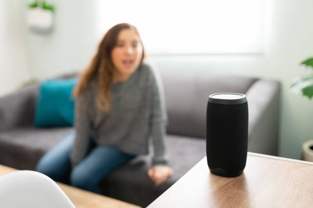 istock Woman in her 20s controlling by voice her smart speaker 1291415191