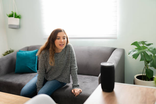 istock Young woman speaking a command to her smart device 1291415198