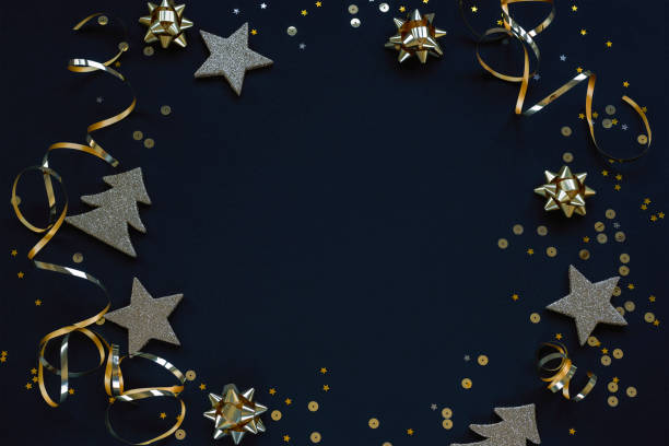 istock Golden Christmas decorations on black background. Festive flat lay, copy space 1291416761