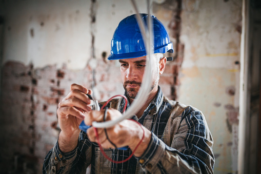 An electrical engineer connects the electricity