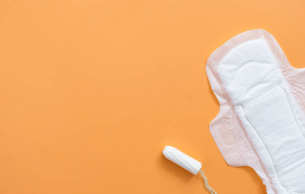 istock Tampon and sanitary pad on orange background 1291417529
