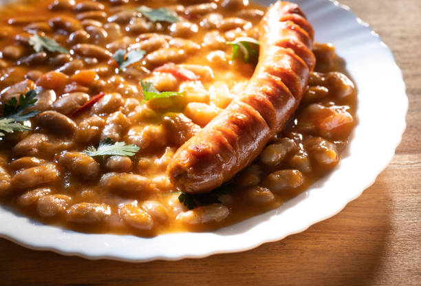istock Baked beans and sausage in a white plate 1291417534