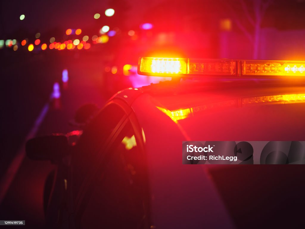 Nightime Police Traffic Stop A police car stopping a vehicle at night. Police Force Stock Photo