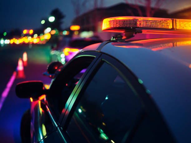 Nightime Police Traffic Stop A police car stopping a vehicle at night. police officer stock pictures, royalty-free photos & images