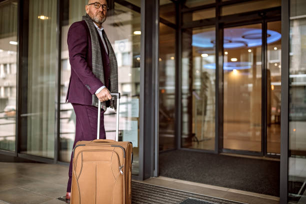istock Senior businessman checking out from hotel 1291419953