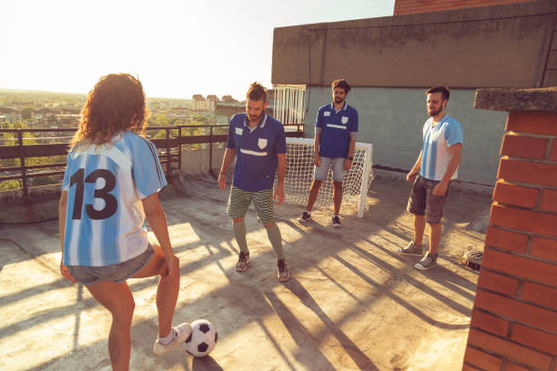 istock Friends playing football 1291420103
