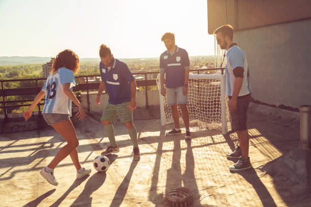 istock Friends having fun playing football 1291420144