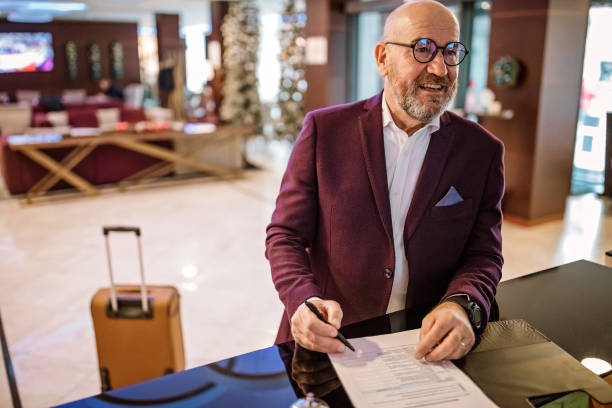 istock Senior businessman checking out from hotel 1291420188