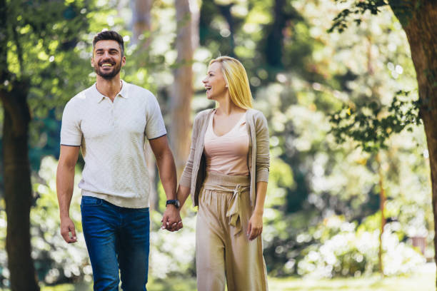 istock Happy couple in love walking in park 1291421138