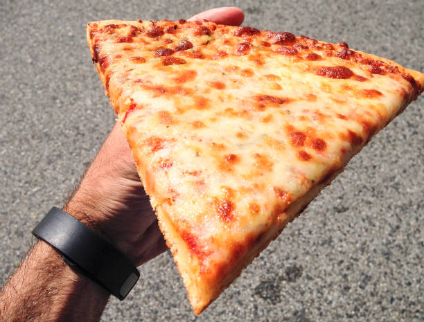 istock man holding a slice of pizza 1291422793
