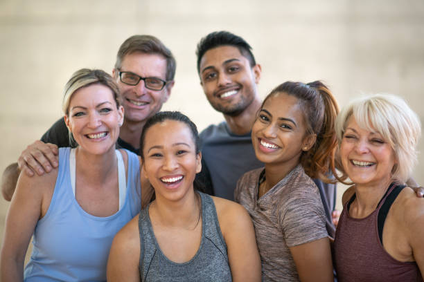 Beautiful smiling faces of a multi ethnic group of fitness enthusiasts. They are all wearing athletic clothing and smiling at the camera.