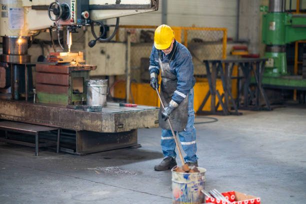 istock The worker sweeps the factory floor 1291425606