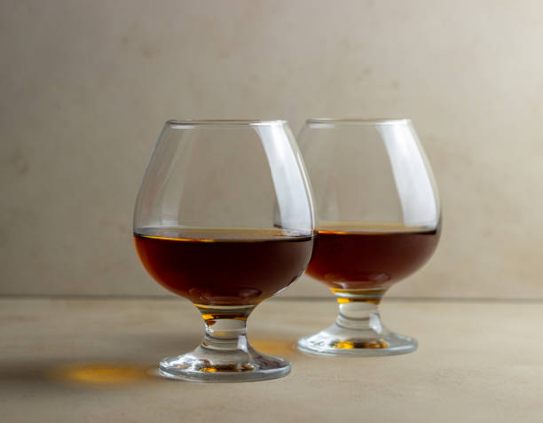 istock Cognac in a glass on a beige background. Alcoholic beverages. Bar. 1291425751