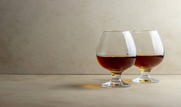 istock Cognac in a glass on a beige background. Alcoholic beverages. Bar. 1291425803