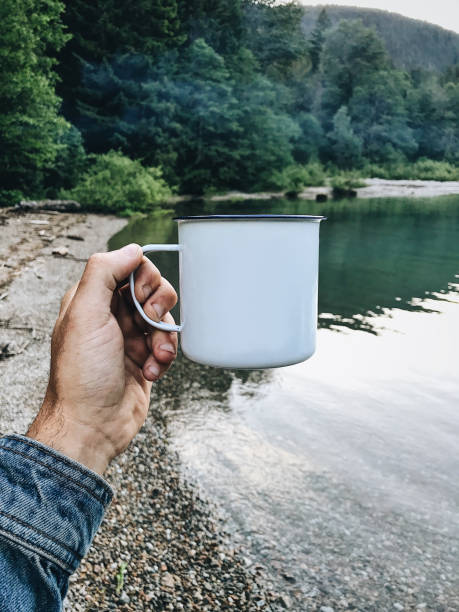 istock holding a mug at the lake 1291426800