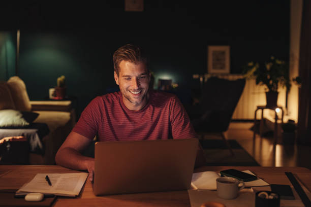 istock Handsome Young Man Working on a Laptop at Home 1291430252