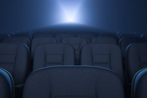 Empty cinema hall during the premiere. Rows of armchairs. Working movie projector.