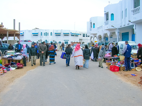 Djerba, Tunisia - December 30, 2007: The local people going at steet market for sale in Djerba, Tunisia