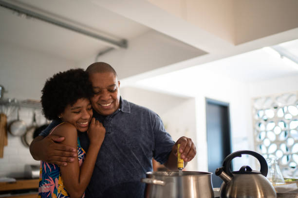 istock Father and daughter embracing while cooking at home 1291437991