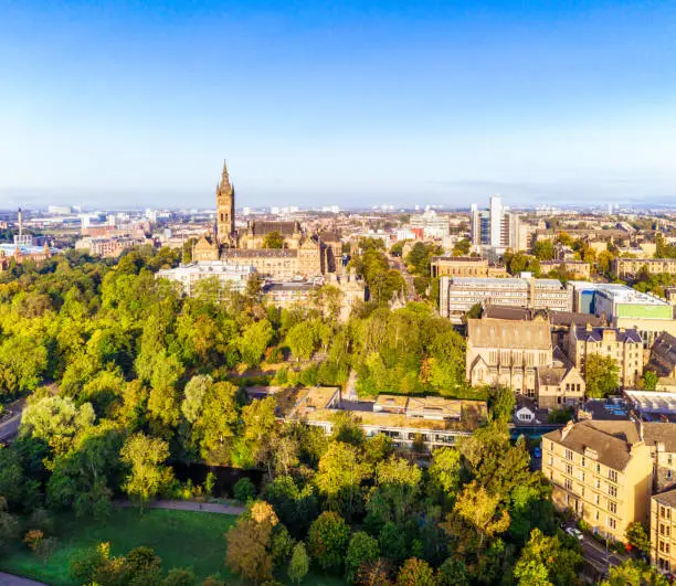An aerial view of part of Glasgow's West End, including the trees of Kelvingrove Park and several Glasgow University buildings.