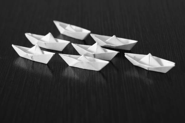 A group of paper boats on the table.