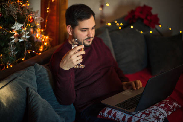 istock Man Celebrating New Year Online With Virtual Friends 1291440768