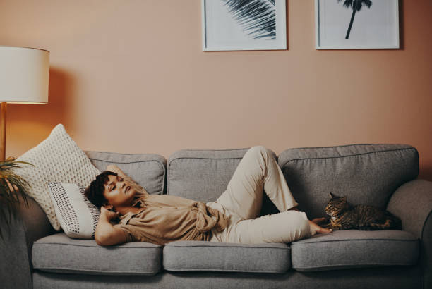 Shot of a young woman relaxing at home with her cat