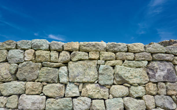 istock Ancient stone wall in near plan 1291441803