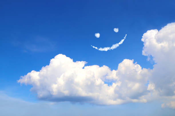 Happy concept. Smilie from white cloud in the blue sky