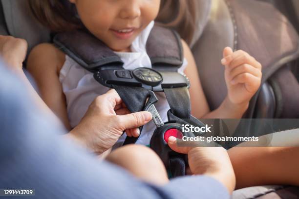 Parent Buckling Her Childs Seat Belt In The Car Transportation Safety Stock Photo - Download Image Now