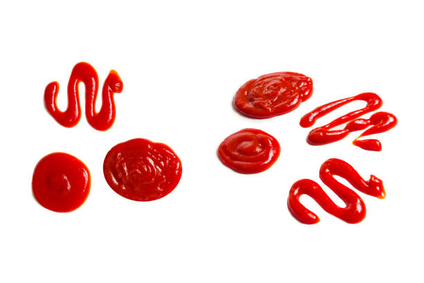 istock Ketchup and yellow sauce splashes isolated on white background. 1291446510