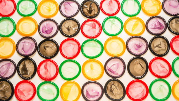 istock Colorful condoms background. 1291446574