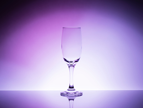 an empty wine glass with a beautiful background. professional advertising shooting of glass