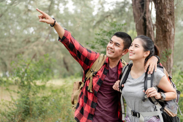 istock Asian couple guiding in the forest 1291448634