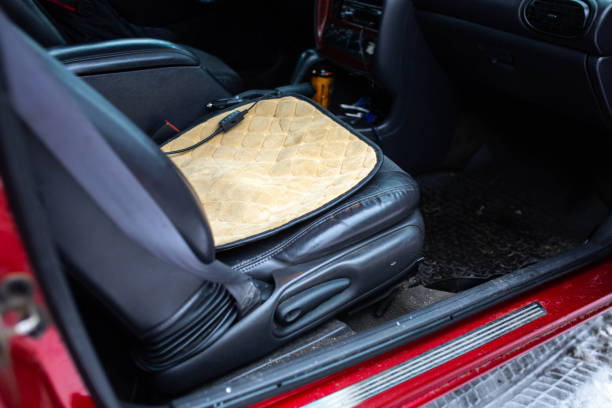 istock portable heated seat in a car with a leather seat. 1291449388