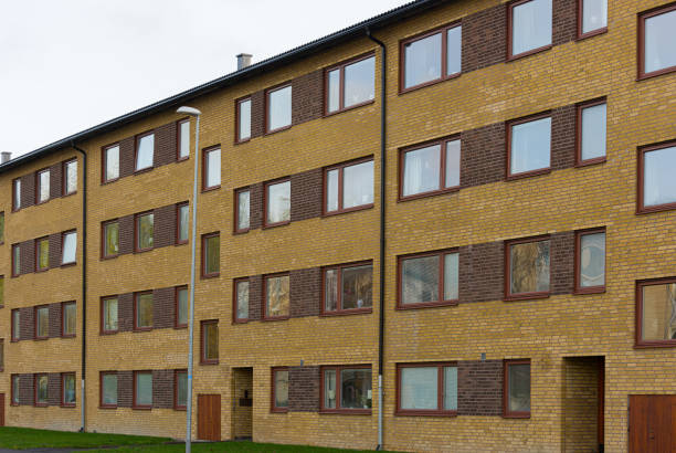 istock Sfor storey yellow brick apartment building.. 1291456509