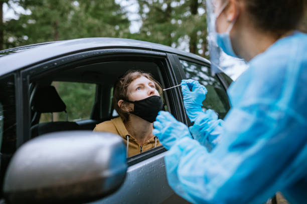 istock Healthcare Worker At Drive Up Testing Center 1291457374