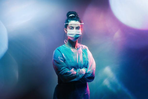Brave Healthcare Worker Wearing PPE A dramatic portrait of female nurse or doctor wearing scrubs and personal protection equipment.  Part of the normal routine, or the new rhythms of COVID-10 / Coronavirus. heroes stock pictures, royalty-free photos & images