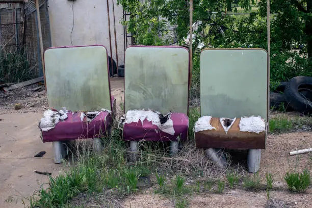 Photo of Tattered bus seats on the roadside