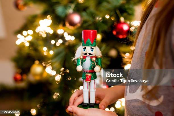 Closeup Of Child Girl Holding Wooden Nutcracker Toy In Hands Christmas Decoration Symbol Stock Photo - Download Image Now