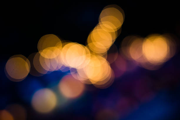 Defocused torchlight background Bokeh effects created by out of focus tiki torches at night. tiki torch stock pictures, royalty-free photos & images